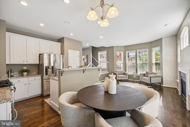8562 Wyngate Manor Ct, Alexandria, VA 22309 - dining room with a chandelier, dark wood-style flooring, recessed lighting, and a fireplace
