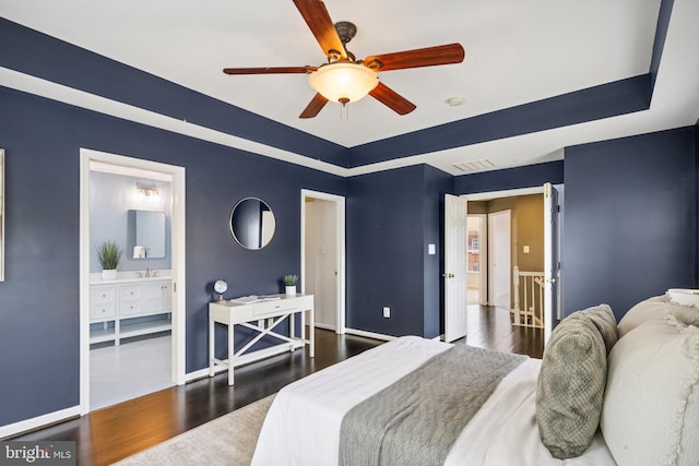 8562 Wyngate Manor Ct, Alexandria, VA 22309 - bedroom featuring a raised ceiling, wood finished floors, connected bathroom, and a ceiling fan
