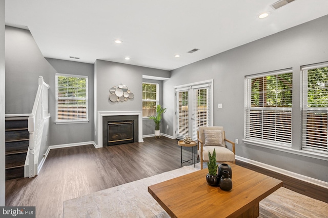 8562 Wyngate Manor Ct, Alexandria, VA 22309 - living area featuring wood finished floors, stairs, a glass covered fireplace, and recessed lighting