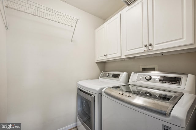 8562 Wyngate Manor Ct, Alexandria, VA 22309 - laundry room with cabinet space and washing machine and dryer