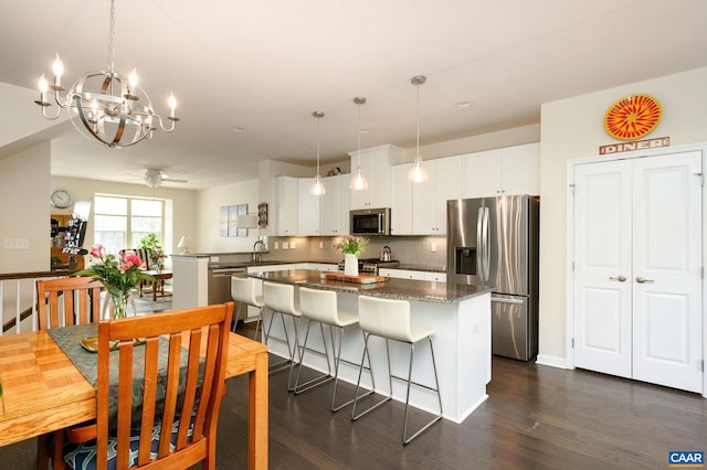 2127 Elm Tree Knl, Charlottesville, VA 22911 - kitchen featuring appliances with stainless steel finishes, dark wood-style floors, a center island, and backsplash