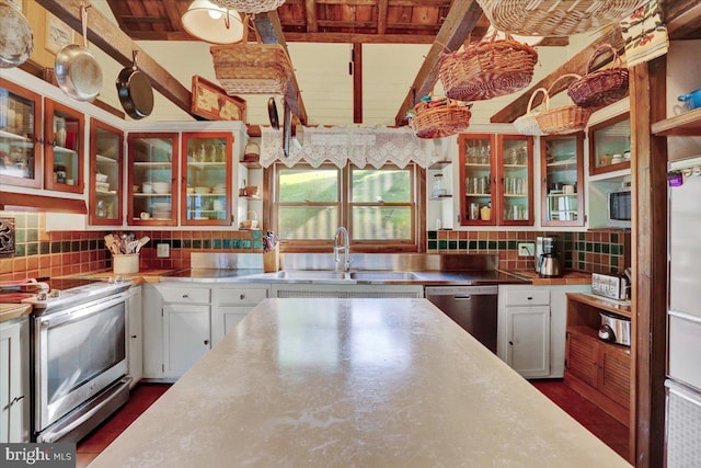 270 Gouglersville Rd, Reading, PA 19608 - kitchen featuring stainless steel counters, stainless steel appliances, backsplash, white cabinetry, and a wooden ceiling with exposed beams