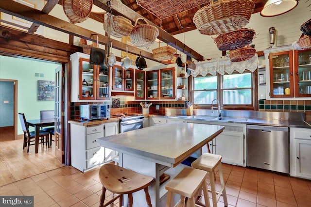 270 Gouglersville Rd, Reading, PA 19608 - kitchen with stainless steel countertops, appliances with stainless steel finishes, light tile patterned flooring, and white cabinetry