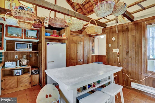270 Gouglersville Rd, Reading, PA 19608 - kitchen with stainless steel microwave, wooden walls, tile patterned flooring, baseboard heating, and healthy amount of natural light