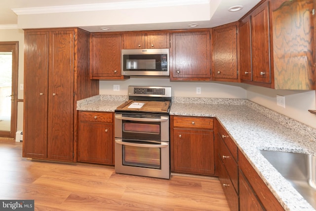 640 Bollinger Rd, Littlestown, PA 17340 - kitchen featuring stainless steel appliances, crown molding, light wood-style flooring, baseboard heating, and light stone countertops