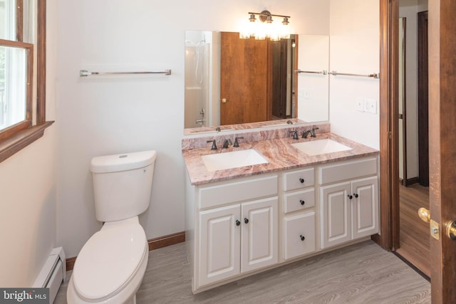 640 Bollinger Rd, Littlestown, PA 17340 - bathroom featuring wood finished floors, baseboard heating, and double vanity