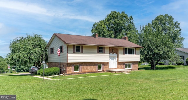 640 Bollinger Rd, Littlestown, PA 17340 - bi-level home with a front lawn, a chimney, and brick siding