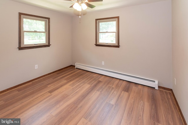 640 Bollinger Rd, Littlestown, PA 17340 - unfurnished room featuring a baseboard heating unit, plenty of natural light, a ceiling fan, and light wood-style flooring
