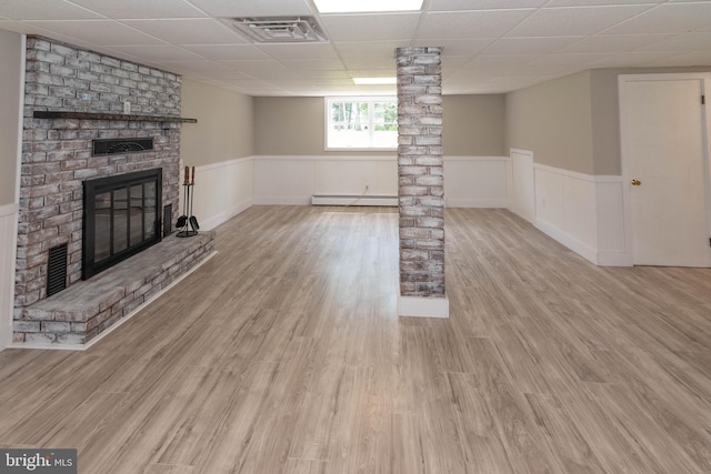 640 Bollinger Rd, Littlestown, PA 17340 - unfurnished living room featuring a paneled ceiling, wainscoting, a fireplace, baseboard heating, and wood finished floors