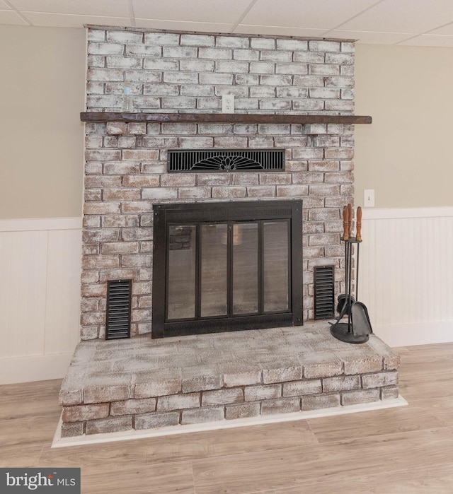 640 Bollinger Rd, Littlestown, PA 17340 - detailed view of a fireplace, wainscoting, wood finished floors, and a decorative wall