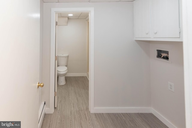 640 Bollinger Rd, Littlestown, PA 17340 - washroom with baseboard heating, washer hookup, light wood-type flooring, and cabinet space