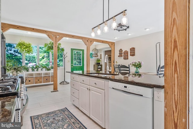 2090 Clearview Dr, Owings, MD 20736 - kitchen featuring dishwasher, stainless steel range with gas stovetop, dark stone counters, white cabinetry, and hanging light fixtures