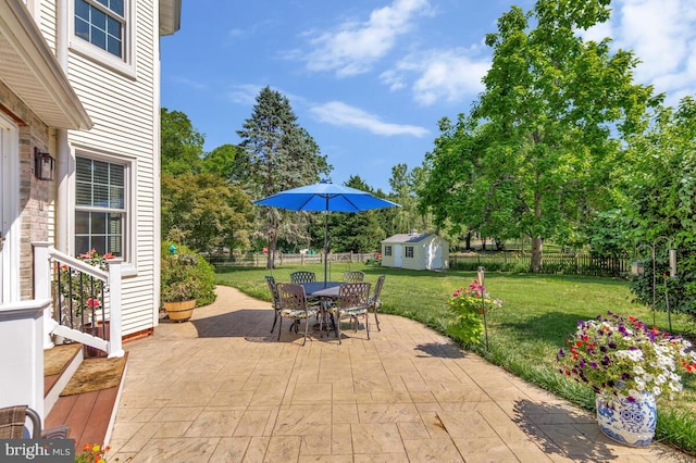 2090 Clearview Dr, Owings, MD 20736 - fenced backyard featuring an outbuilding, a patio, and outdoor dining area