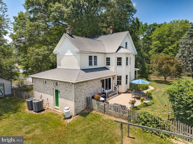2090 Clearview Dr, Owings, MD 20736 - back of house featuring roof with shingles, a patio, a chimney, a fenced backyard, and entry steps