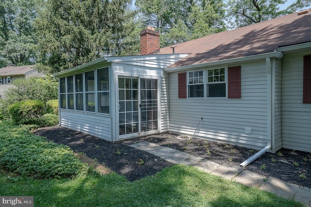 1420 E Boot Rd, West Chester, PA 19380 - view of home's exterior featuring a sunroom, a chimney, and roof with shingles