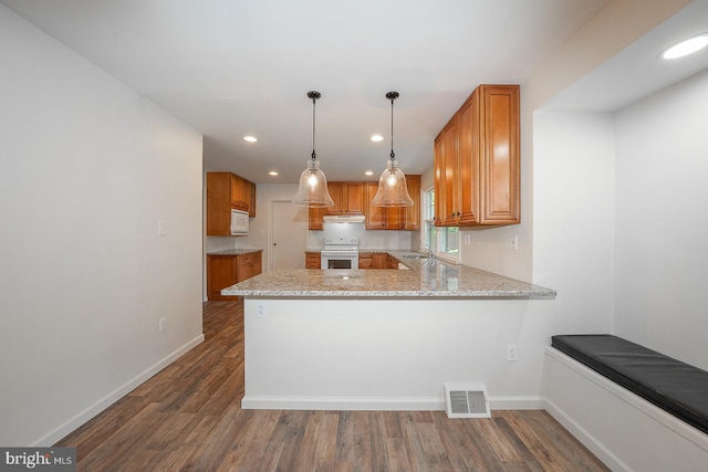 1420 E Boot Rd, West Chester, PA 19380 - kitchen with white appliances, a peninsula, wood finished floors, brown cabinets, and recessed lighting