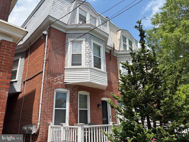 1329 N Dupont St, Wilmington, DE 19806 - view of side of property featuring brick siding and mansard roof