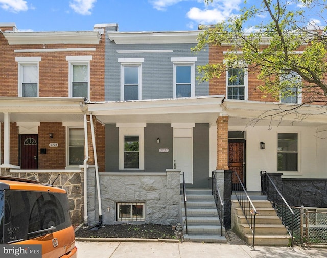 2721 E Chase St, Baltimore, MD 21213 - townhome / multi-family property featuring covered porch and brick siding