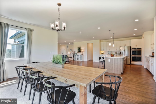 11100 Slate Landing Ln, Nokesville, VA 20181 - dining area featuring wood finished floors, a chandelier, and recessed lighting