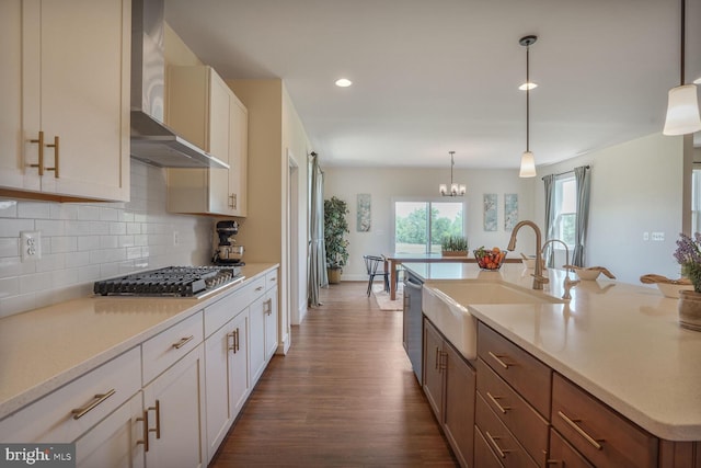 11100 Slate Landing Ln, Nokesville, VA 20181 - kitchen featuring wall chimney range hood, appliances with stainless steel finishes, dark wood-style flooring, backsplash, and light countertops