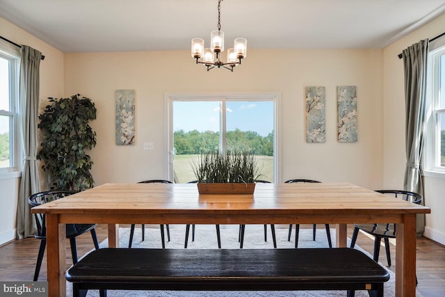 11100 Slate Landing Ln, Nokesville, VA 20181 - dining space with dark wood finished floors, a chandelier, and healthy amount of natural light