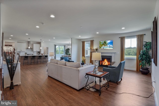 11100 Slate Landing Ln, Nokesville, VA 20181 - living room with recessed lighting, a warm lit fireplace, and dark wood-style flooring