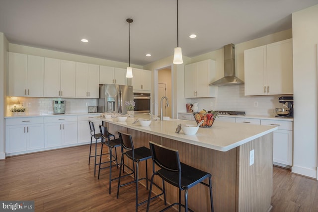 11100 Slate Landing Ln, Nokesville, VA 20181 - kitchen with wall chimney exhaust hood, appliances with stainless steel finishes, decorative backsplash, white cabinets, and recessed lighting