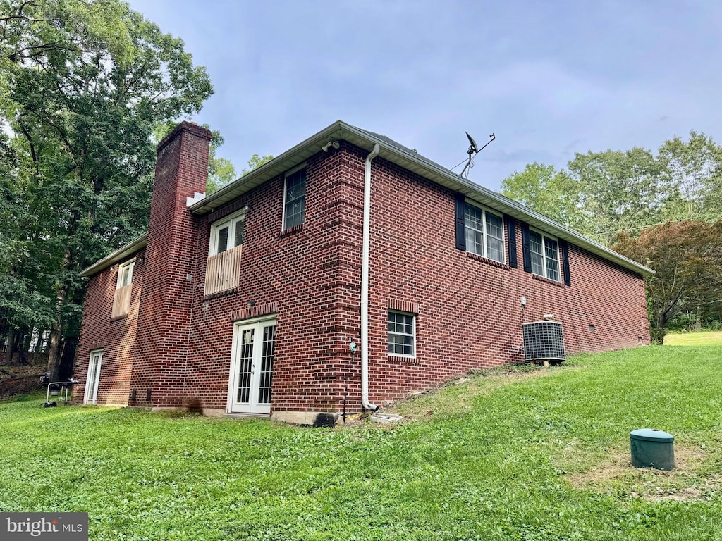 311 Akern Ln, Cross Junction, VA 22625 - view of side of home with a chimney, brick siding, a yard, and french doors