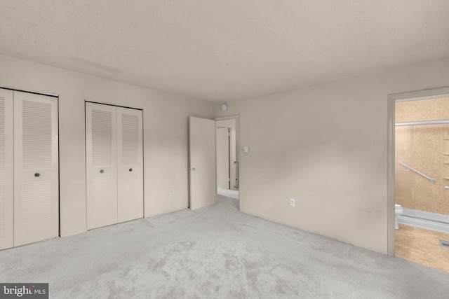 1848 Statesman Ct, Severn, MD 21144 - unfurnished bedroom featuring multiple closets, carpet flooring, and ensuite bath