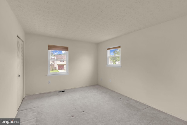 1848 Statesman Ct, Severn, MD 21144 - unfurnished bedroom featuring carpet flooring, a textured ceiling, and a closet