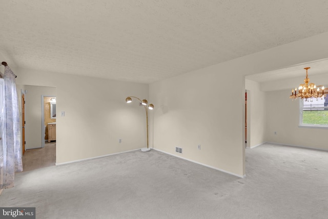 1848 Statesman Ct, Severn, MD 21144 - unfurnished room with light colored carpet, a chandelier, and a textured ceiling