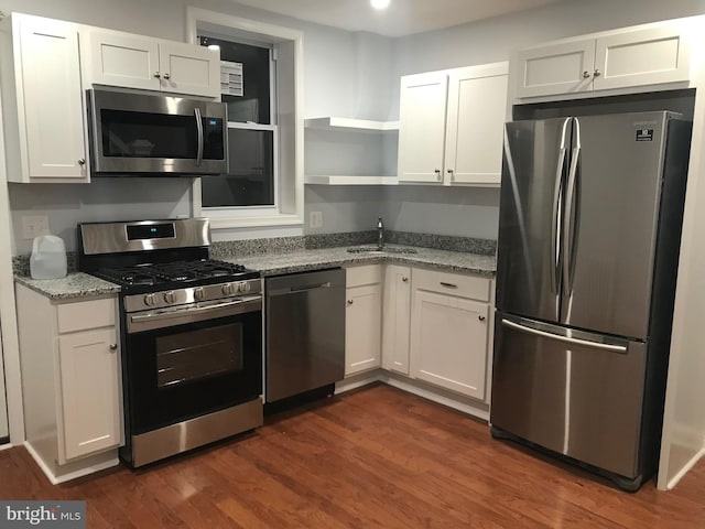 2813 Miles Ave, Baltimore, MD 21211 - kitchen featuring stainless steel appliances, open shelves, white cabinetry, and light stone counters