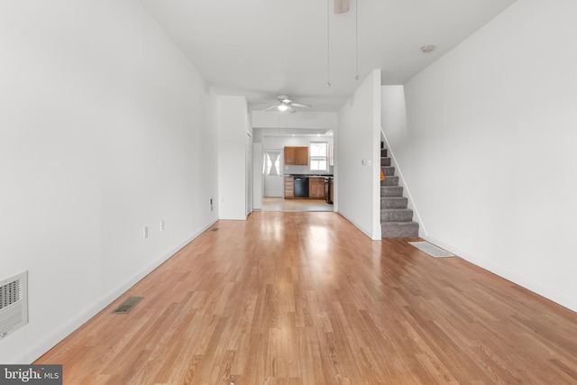 3915 Falls Rd, Baltimore, MD 21211 - unfurnished living room with a ceiling fan, light wood finished floors, and stairway