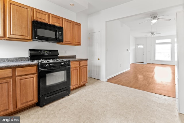3915 Falls Rd, Baltimore, MD 21211 - kitchen featuring black appliances, dark countertops, ceiling fan, and brown cabinetry