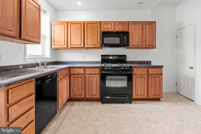3915 Falls Rd, Baltimore, MD 21211 - kitchen with black appliances, dark countertops, light flooring, brown cabinetry, and recessed lighting
