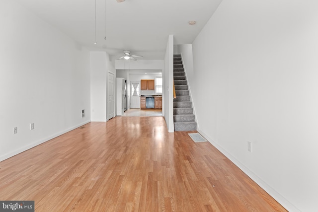 3915 Falls Rd, Baltimore, MD 21211 - unfurnished living room featuring light wood-style floors, stairway, and ceiling fan