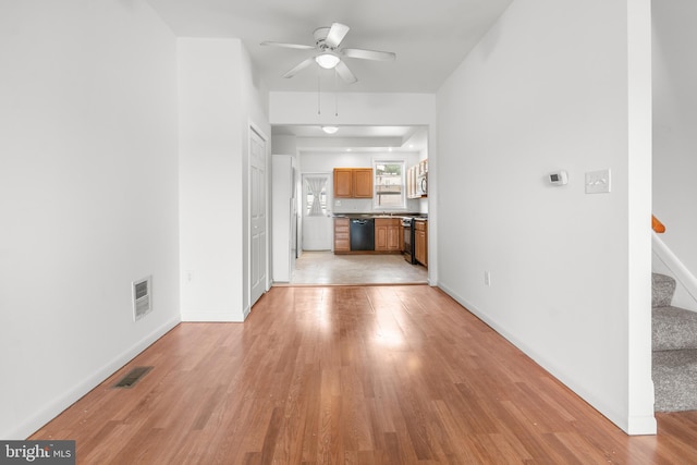 3915 Falls Rd, Baltimore, MD 21211 - unfurnished living room with light wood-type flooring, stairway, and ceiling fan