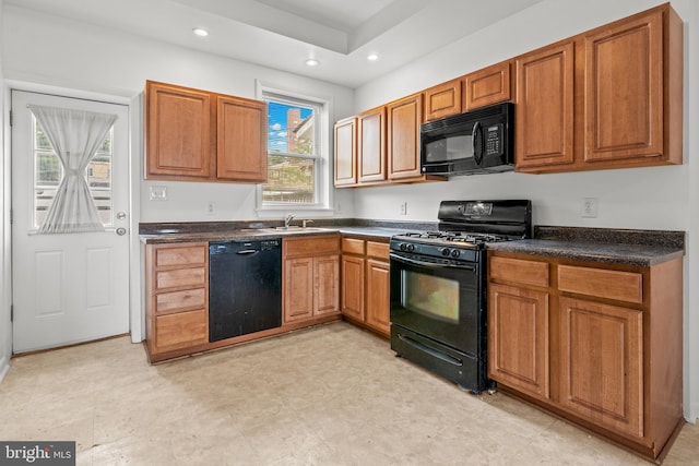 3915 Falls Rd, Baltimore, MD 21211 - kitchen with black appliances, dark countertops, recessed lighting, and brown cabinetry