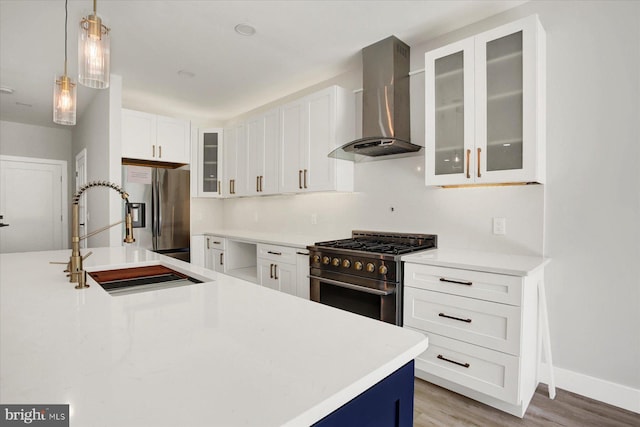 51FRANKLINDR Franklin Dr, Mechanicsburg, PA 17055 - kitchen featuring wall chimney exhaust hood, appliances with stainless steel finishes, light wood-type flooring, white cabinets, and light countertops