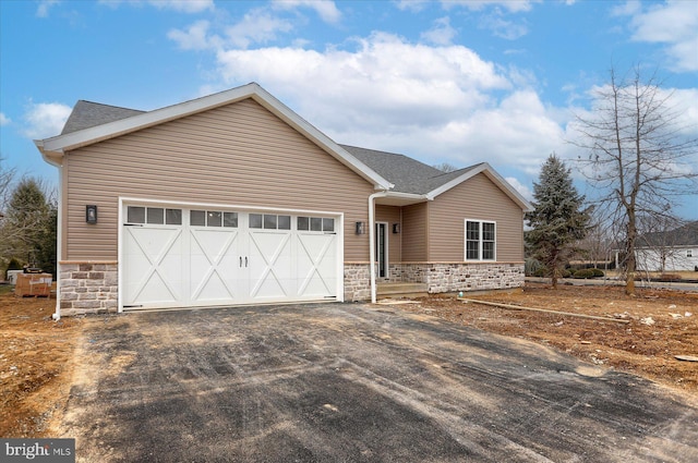 51FRANKLINDR Franklin Dr, Mechanicsburg, PA 17055 - view of front facade featuring stone siding, driveway, an attached garage, and roof with shingles