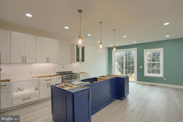 51FRANKLINDR Franklin Dr, Mechanicsburg, PA 17055 - kitchen with high end stove, white cabinets, light wood-type flooring, a center island, and recessed lighting