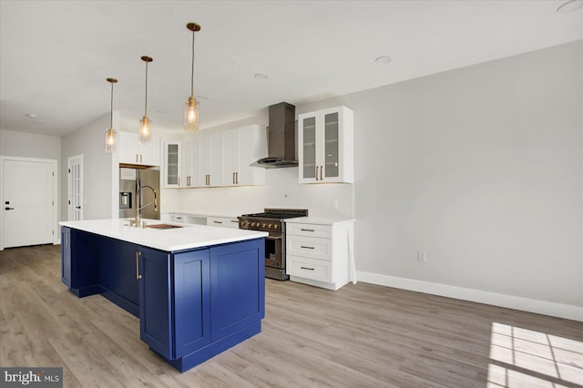 51FRANKLINDR Franklin Dr, Mechanicsburg, PA 17055 - kitchen featuring wall chimney range hood, stainless steel appliances, light wood-type flooring, white cabinetry, and light countertops