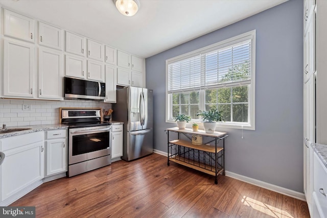 213 Buchanan Ct, Downingtown, PA 19335 - kitchen featuring appliances with stainless steel finishes, decorative backsplash, white cabinetry, and dark wood-type flooring