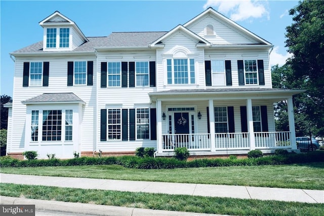 43314 Fullerton St, Ashburn, VA 20147 - view of front of home featuring covered porch and a front lawn