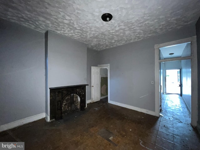 2532 W Baltimore St, Baltimore, MD 21223 - unfurnished living room with a textured ceiling and baseboards