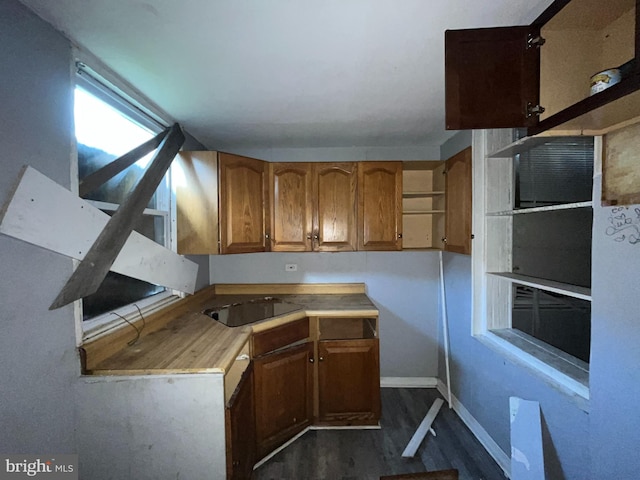 2532 W Baltimore St, Baltimore, MD 21223 - kitchen with dark wood-style flooring, brown cabinets, black electric cooktop, and light countertops
