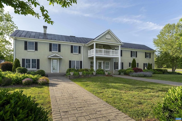 928 Slate Mill Rd Unit B, Stanardsville, VA 22973 - view of front of property featuring a balcony, a front yard, stucco siding, and a metal roof