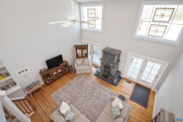 928 Slate Mill Rd Unit B, Stanardsville, VA 22973 - living room featuring a high ceiling, a wood stove, wood finished floors, and a ceiling fan