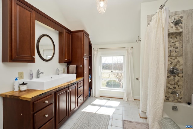 928 Slate Mill Rd Unit B, Stanardsville, VA 22973 - full bathroom with tile patterned floors, vanity, shower / bath combo with shower curtain, and vaulted ceiling