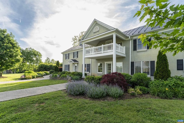 928 Slate Mill Rd Unit B, Stanardsville, VA 22973 - view of front of home featuring a standing seam roof, stucco siding, a metal roof, a balcony, and a front lawn